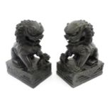 A pair of Chinese carved hardstone foo dogs / guardian lions with ball underfoot and loose ball