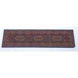 Carpet / Rug : A blue ground runner decorated with three central medallions with floral and scroll
