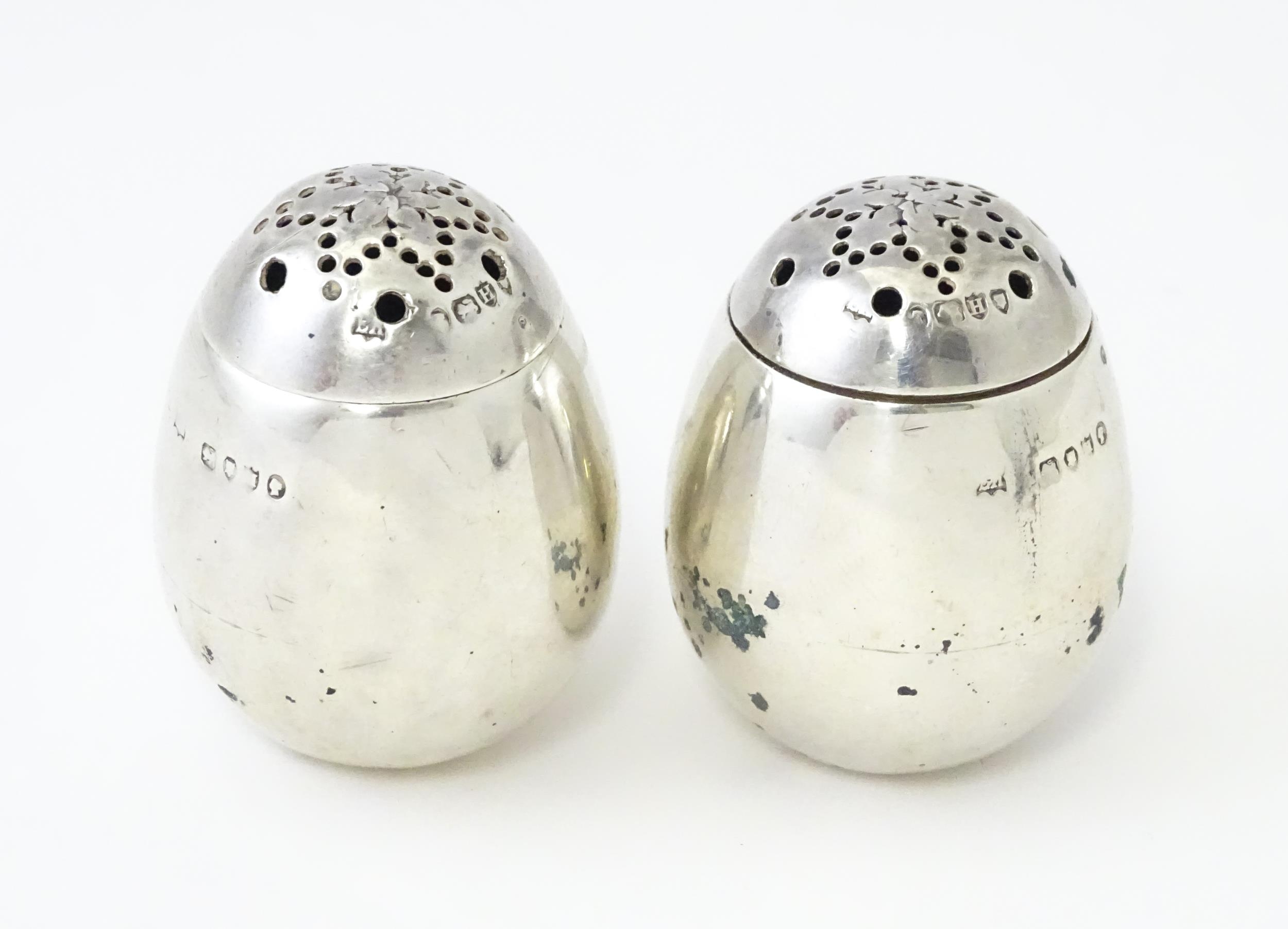 A pair of Victorian silver pepperettes of egg form. Hallmarked London 1883 maker William Hutton &