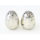 A pair of Victorian silver pepperettes of egg form. Hallmarked London 1883 maker William Hutton &