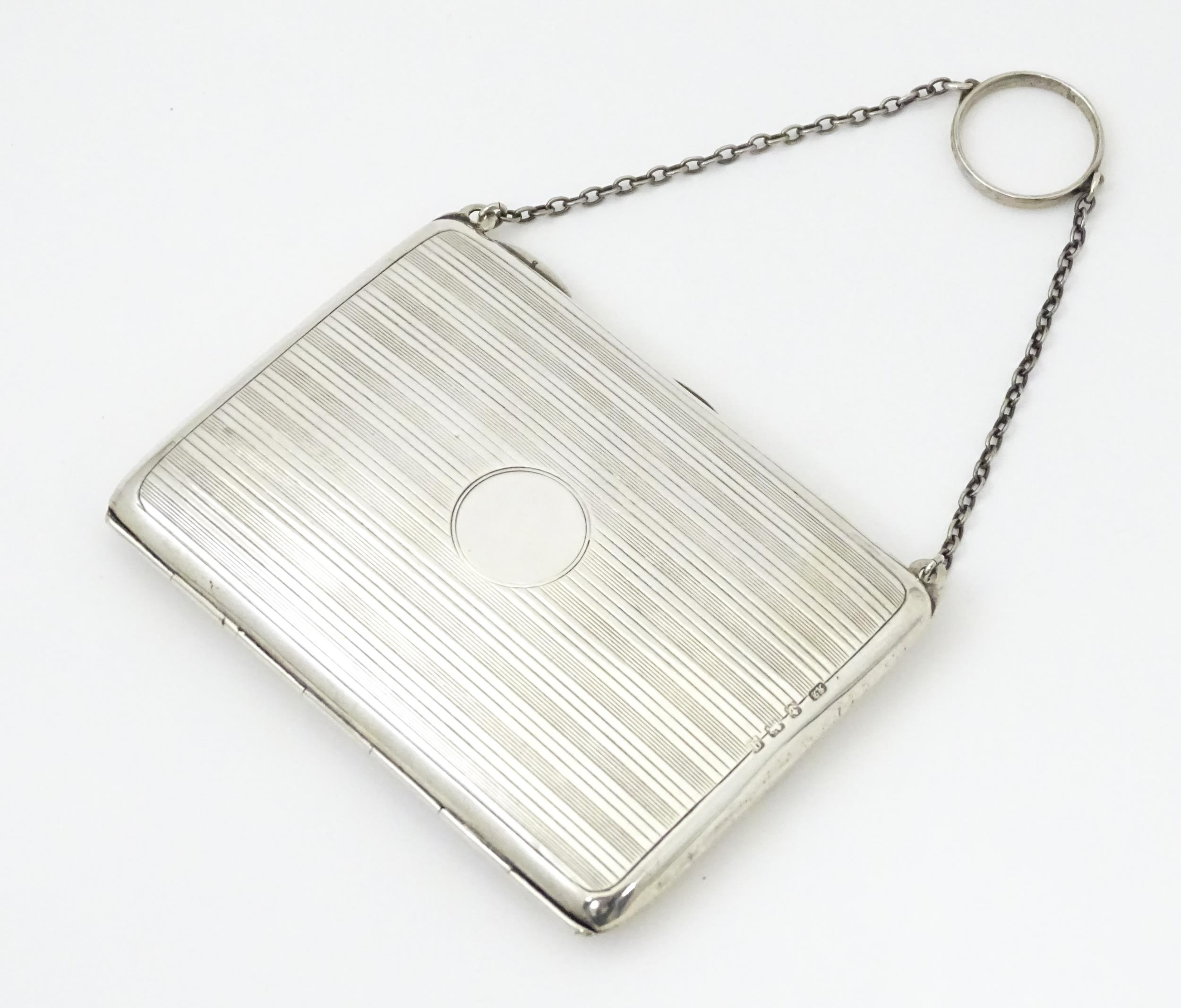 A silver purse / dance card case with leather lined interior. Hallmarked Birmingham, 1915 maker