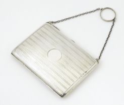 A silver purse / dance card case with leather lined interior. Hallmarked Birmingham, 1915 maker