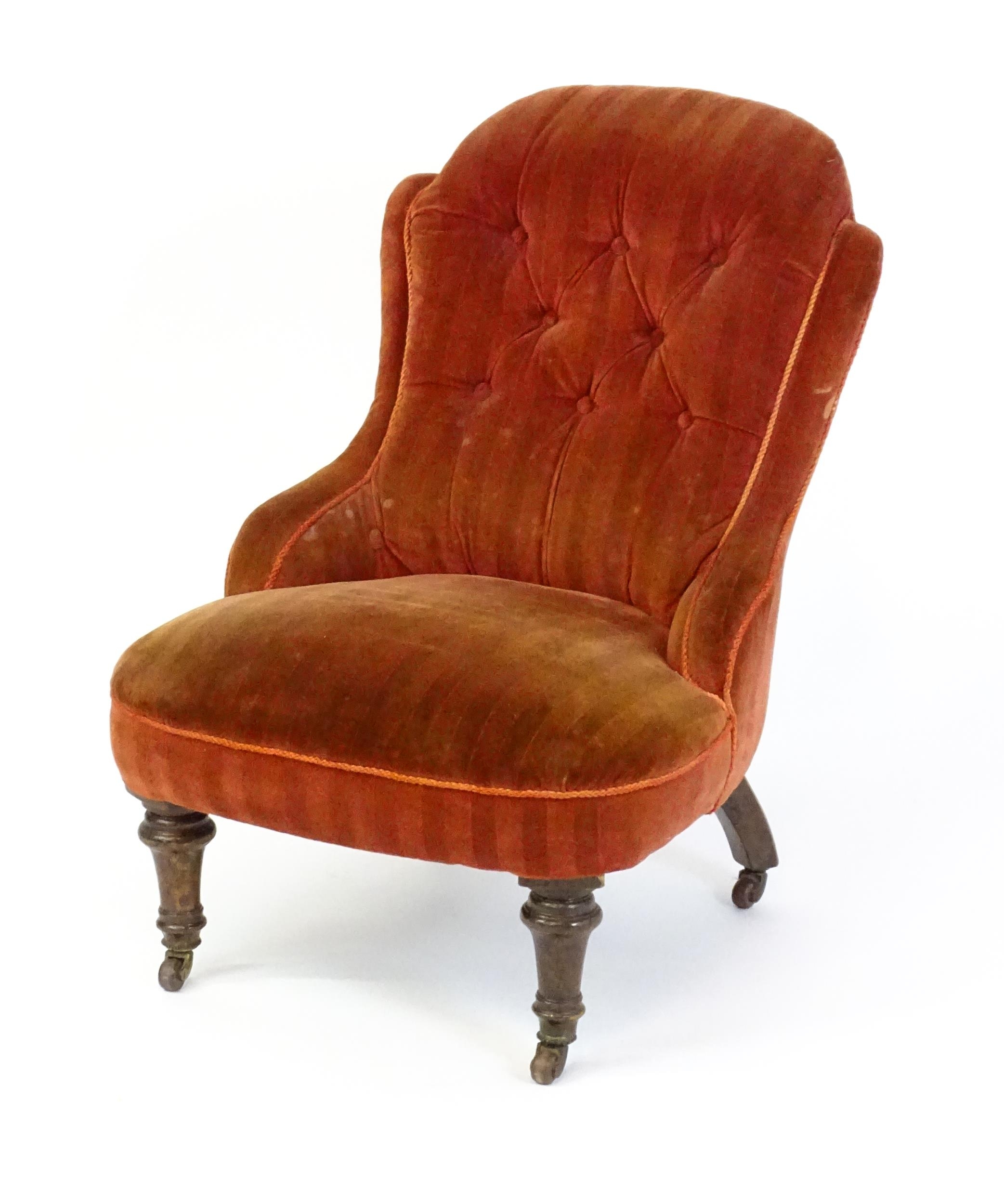 A late 19thC / early 20thC nursing chair with a deep buttoned backrest, sprung seat and raised on - Image 3 of 5