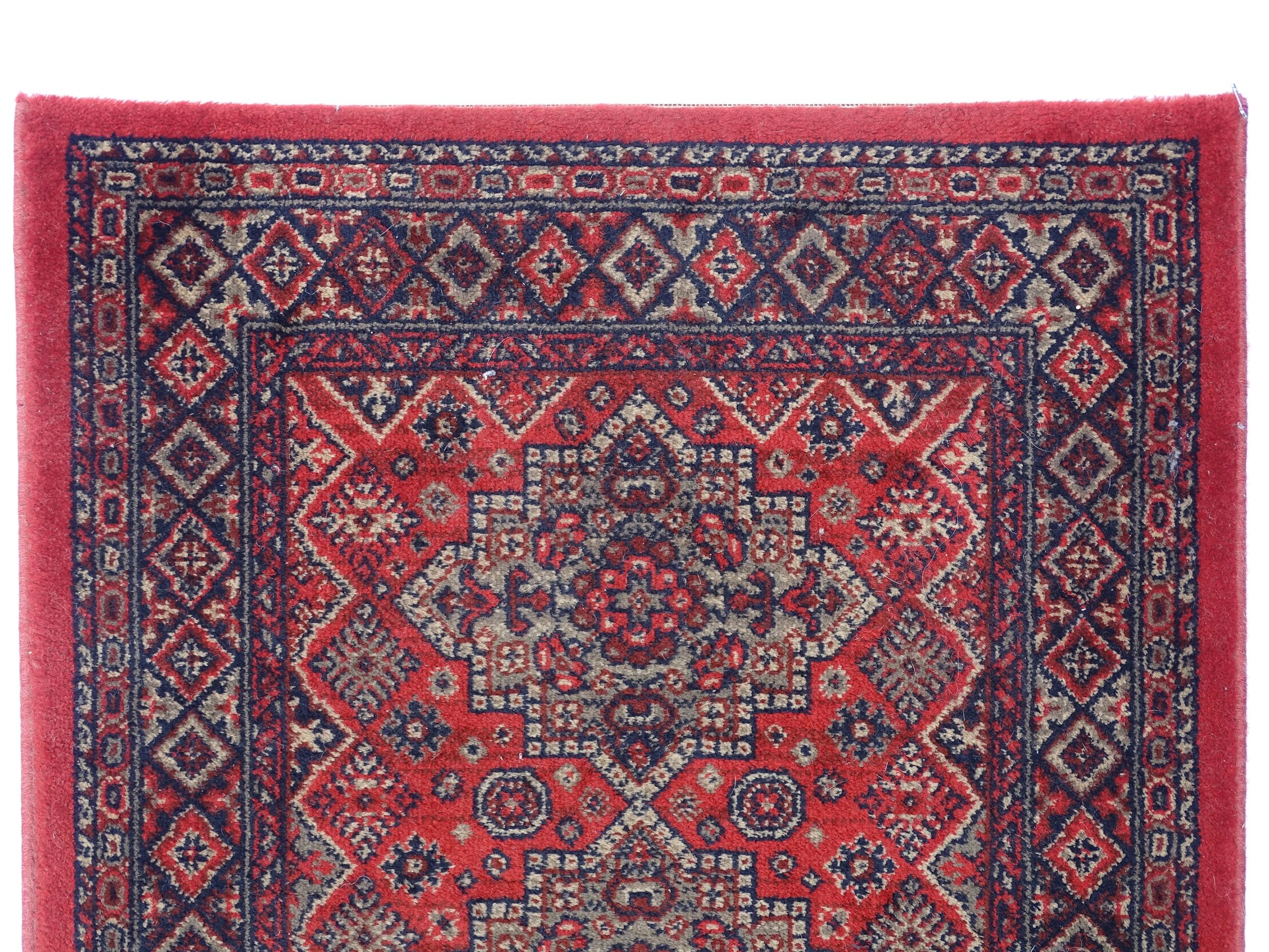 Carpet / Rug : A red ground runner with repeating motifs to centre, bordered by geometric banding. - Image 4 of 8