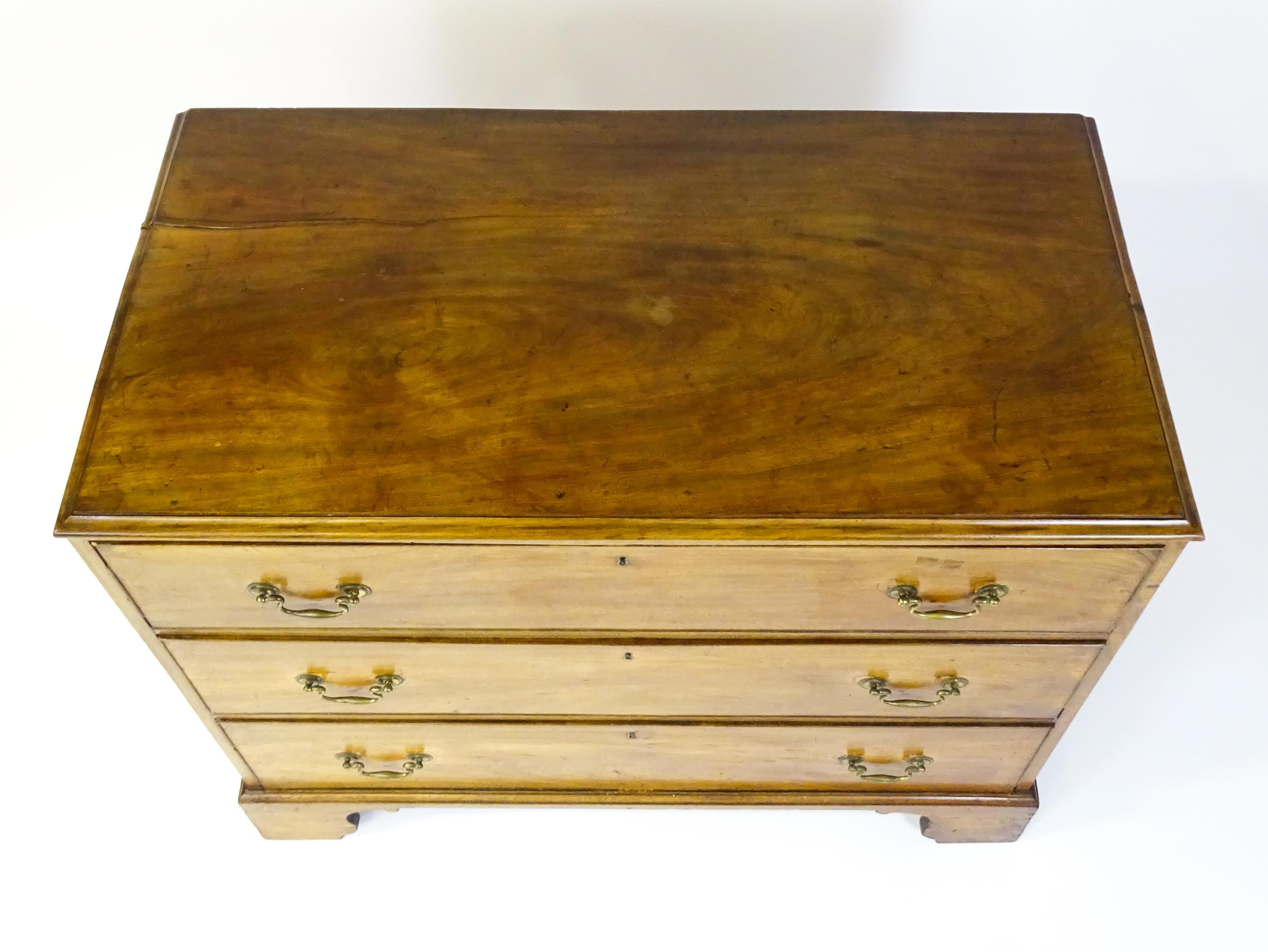 A late Georgian mahogany chest of drawers with a rectangular moulded top above three long drawers - Image 4 of 10