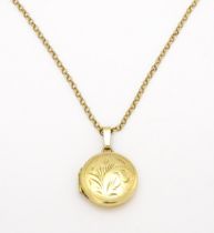 A 9ct gold locket with engraved detail on a 9ct gold chain. Locket approx. 5/8" wide Please Note -