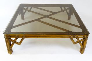 A late 20thC bamboo style glass topped coffee table. 48" wide x 48" deep x 15" high. Please Note -