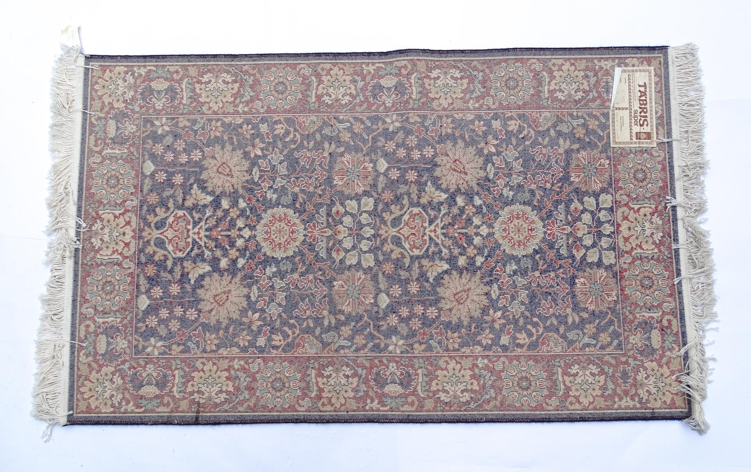 Carpet / Rug : A blue ground wool rug decorated with floral and foliate detail, further repeated - Image 2 of 9