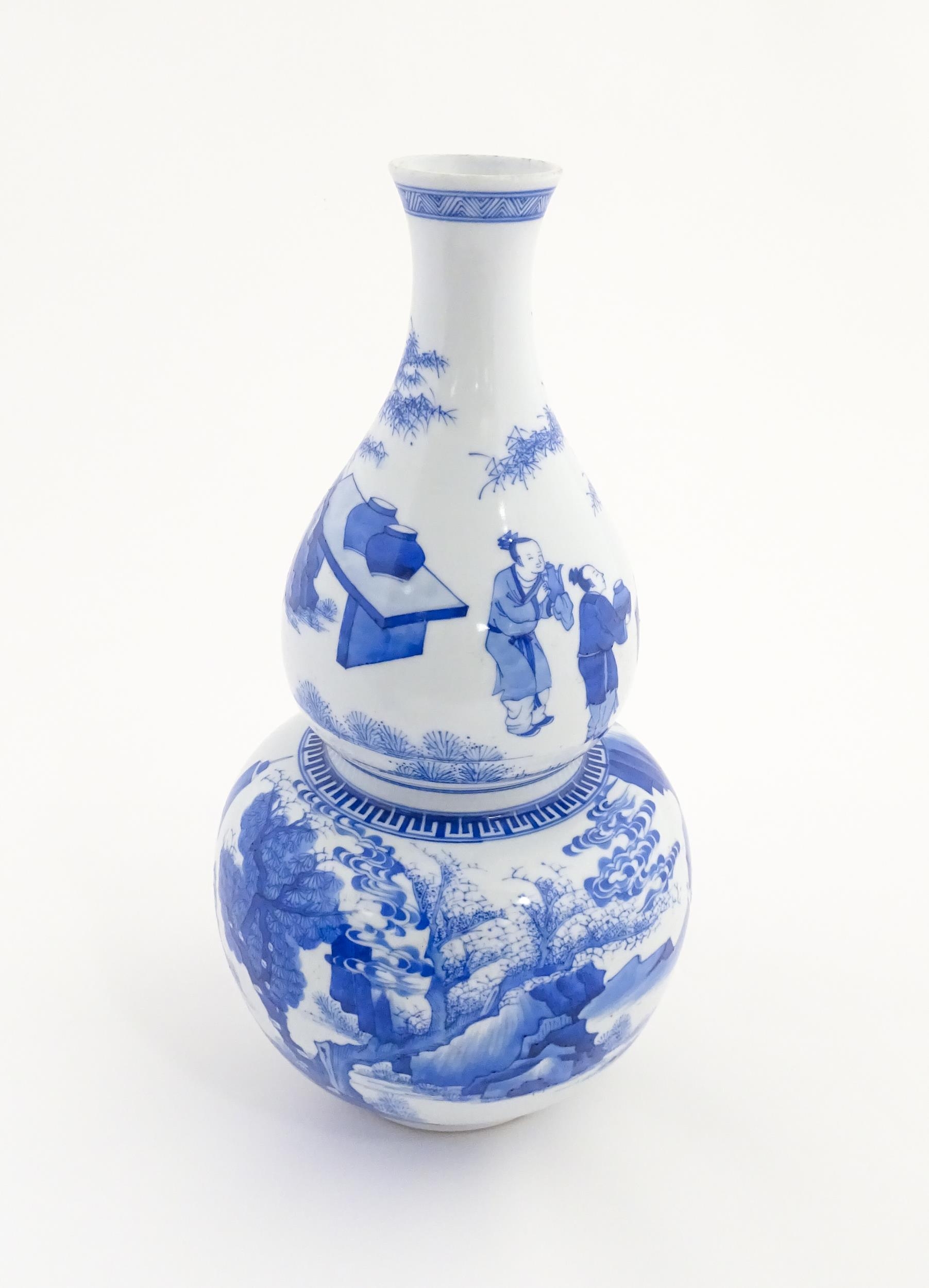 A Chinese blue and white double gourd vase decorated with figures in a landscape. Approx. 16 1/4" - Image 5 of 7