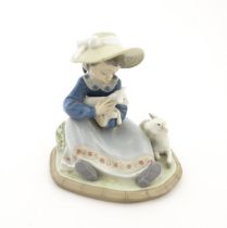 A Lladro model Lambkins, model no. 5469. Marked under. With box. Approx. 5 3/4" high Please Note -