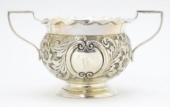 A Victorian silver twin handled bowl with embossed floral and foliate decoration, hallmarked Chester