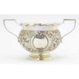 A Victorian silver twin handled bowl with embossed floral and foliate decoration, hallmarked Chester