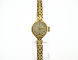 A 9ct gold cased ladies wristwatch by Rotary with 9ct gold bracelet strap . Approx 1/2" wide