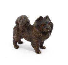 A 20thC cast bronze model of a Pomeranian dog with red painted eyes. Approx. 2 1/4" high Please Note