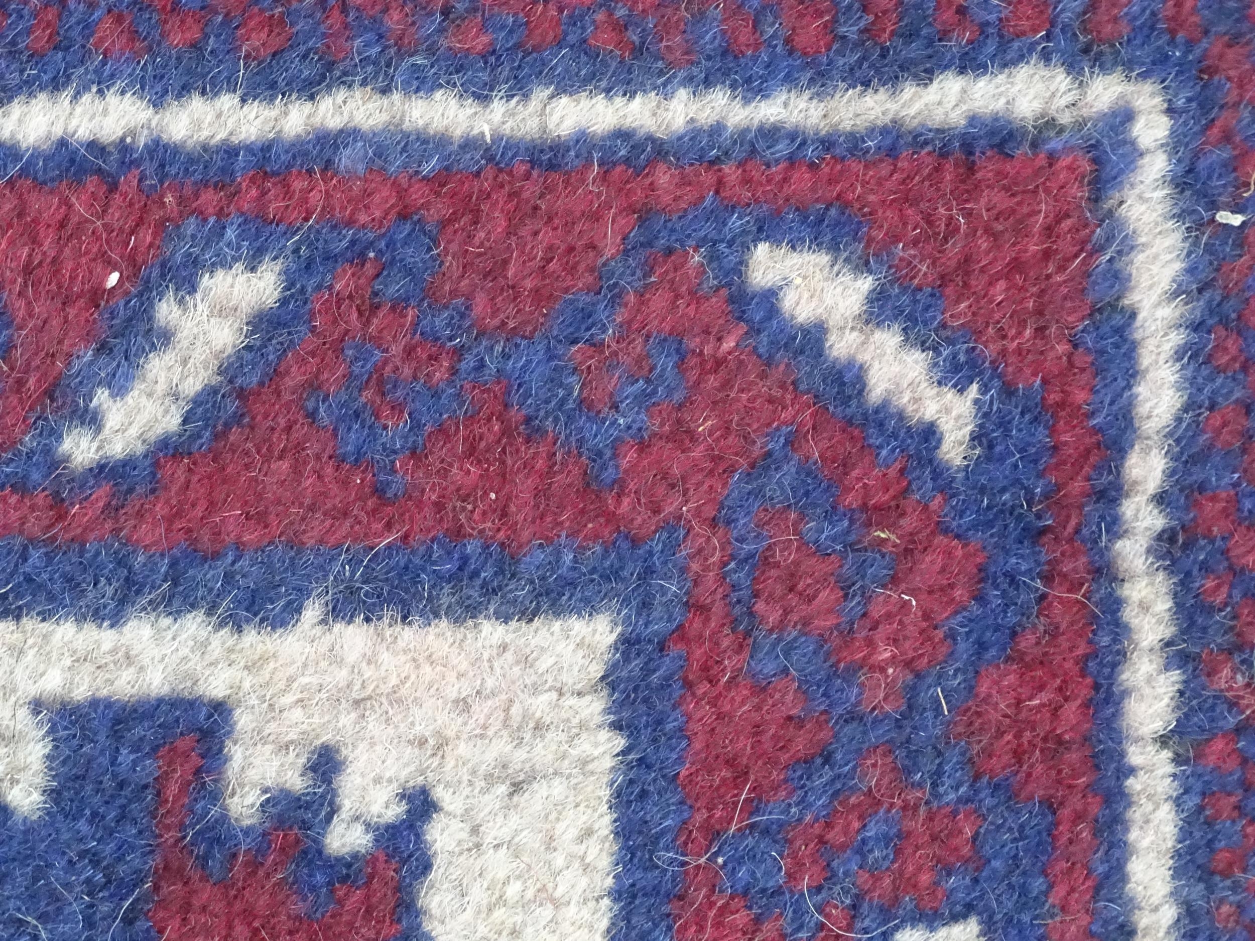 Carpet / Rug : A red, blue and cream ground rug with repeating geometric motifs. Approx. 55" x 29" - Image 7 of 7