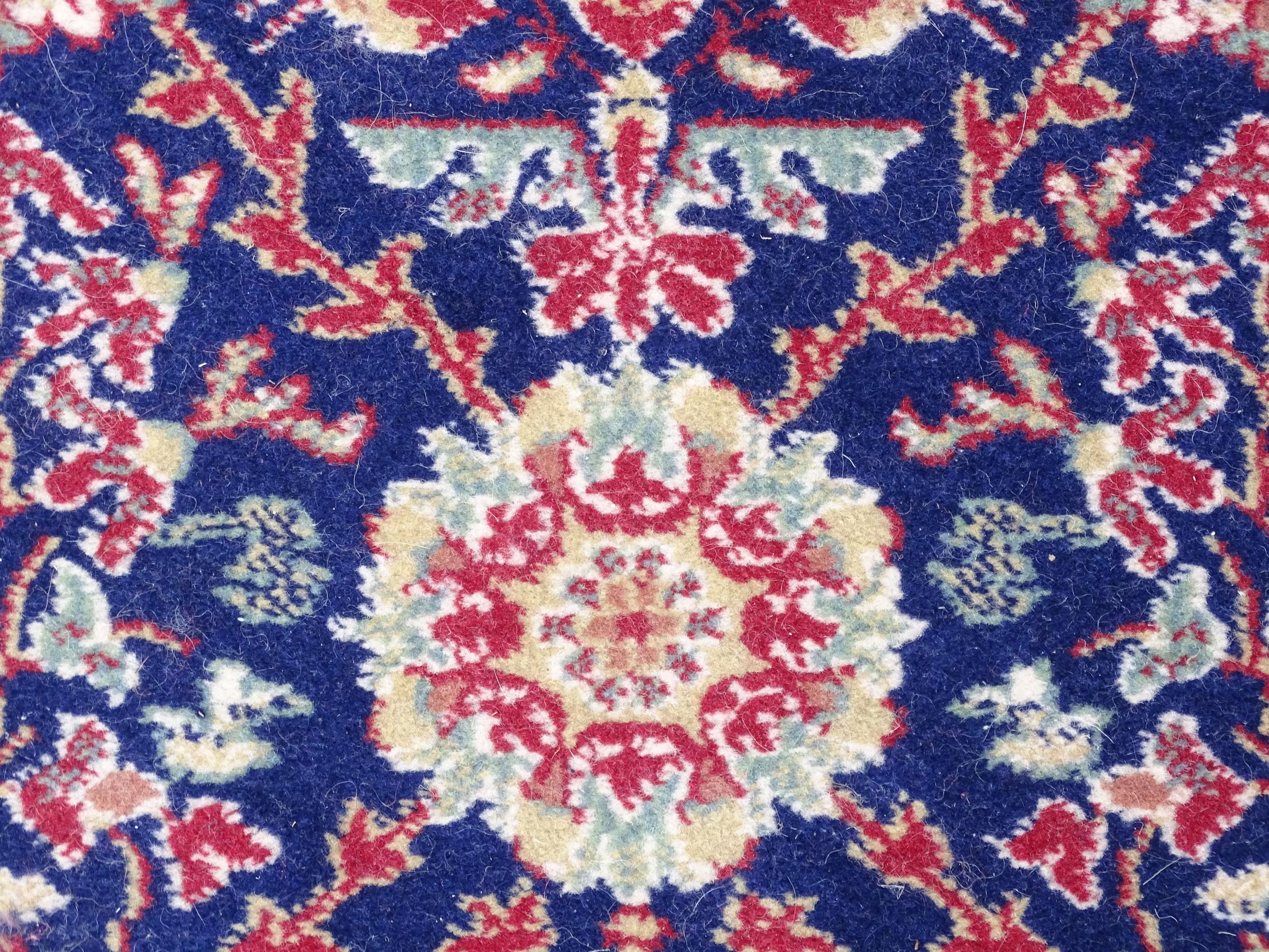 Carpet / Rug : A blue ground wool rug decorated with floral and foliate detail, further repeated - Image 5 of 9