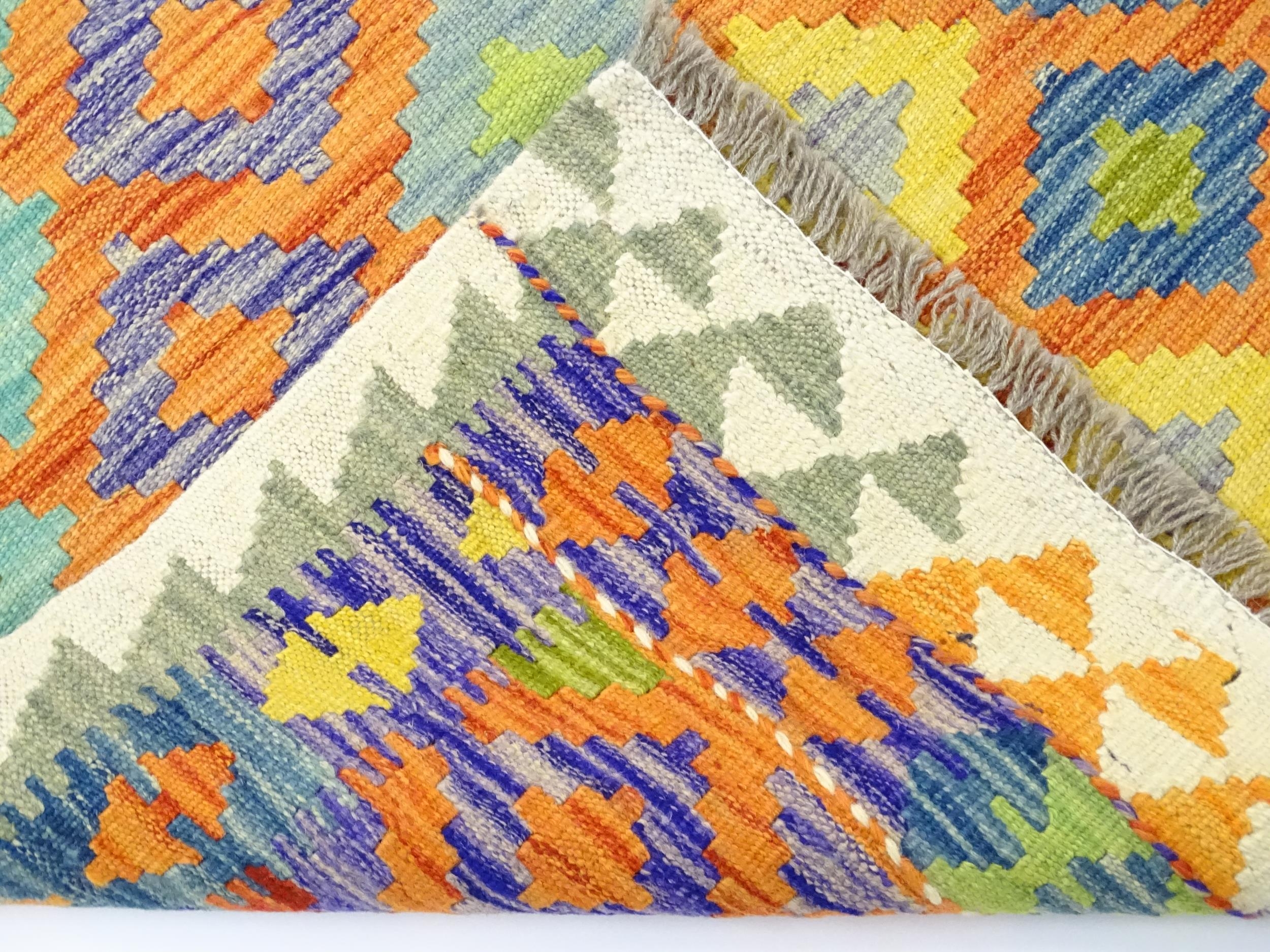 Carpet / Rug : A Turkish Anatolian kilim rug with repeated geometric motifs. Approx. 84" x 59" - Image 2 of 6