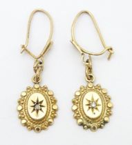 A pair of 9ct gold drop earrings set with diamonds. Approx. 1" long Please Note - we do not make