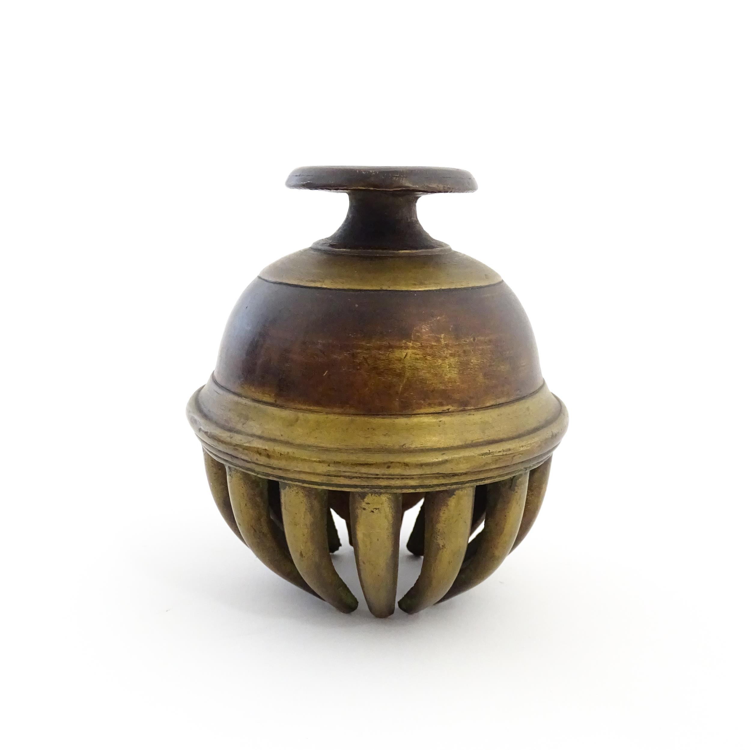 An Indian brass elephant claw bell. Together with a crotal bell marked AD and HN. Claw bell - Image 6 of 13