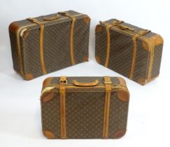 Louis Vuitton Luggage : Three graduated Louis Vuitton monogram suitcases with double strap detail.