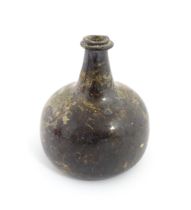 A late 18thC / early 19thC English dark olive green glass onion shape wine bottle. Approx. 6" high