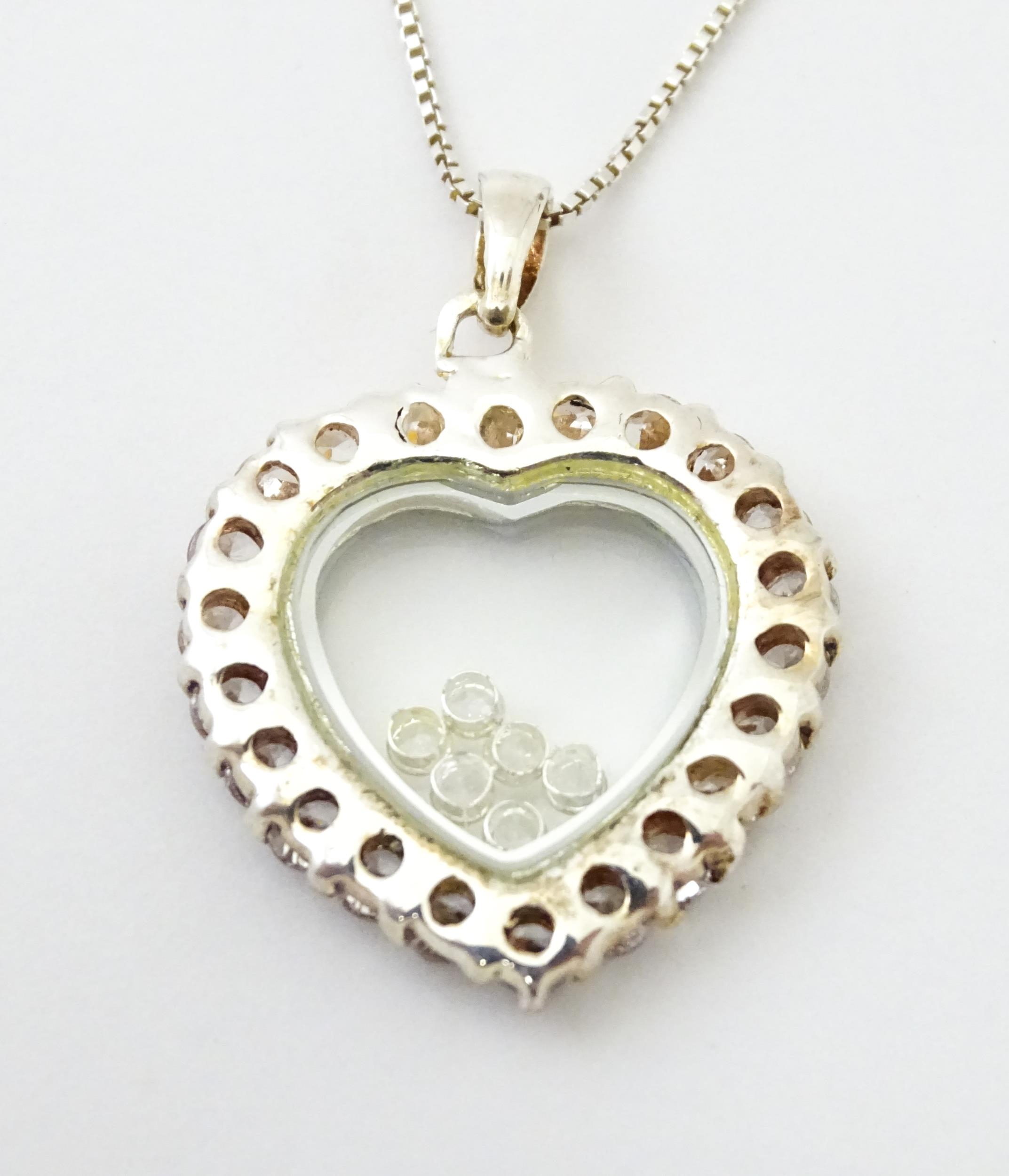 A silver chain with heart shaped locket pendant set with white stones with further white stones - Image 4 of 6