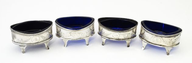 A set of four Geo III silver salts with blue glass liners, hallmarked Newcastle c. 1790. Approx. 3