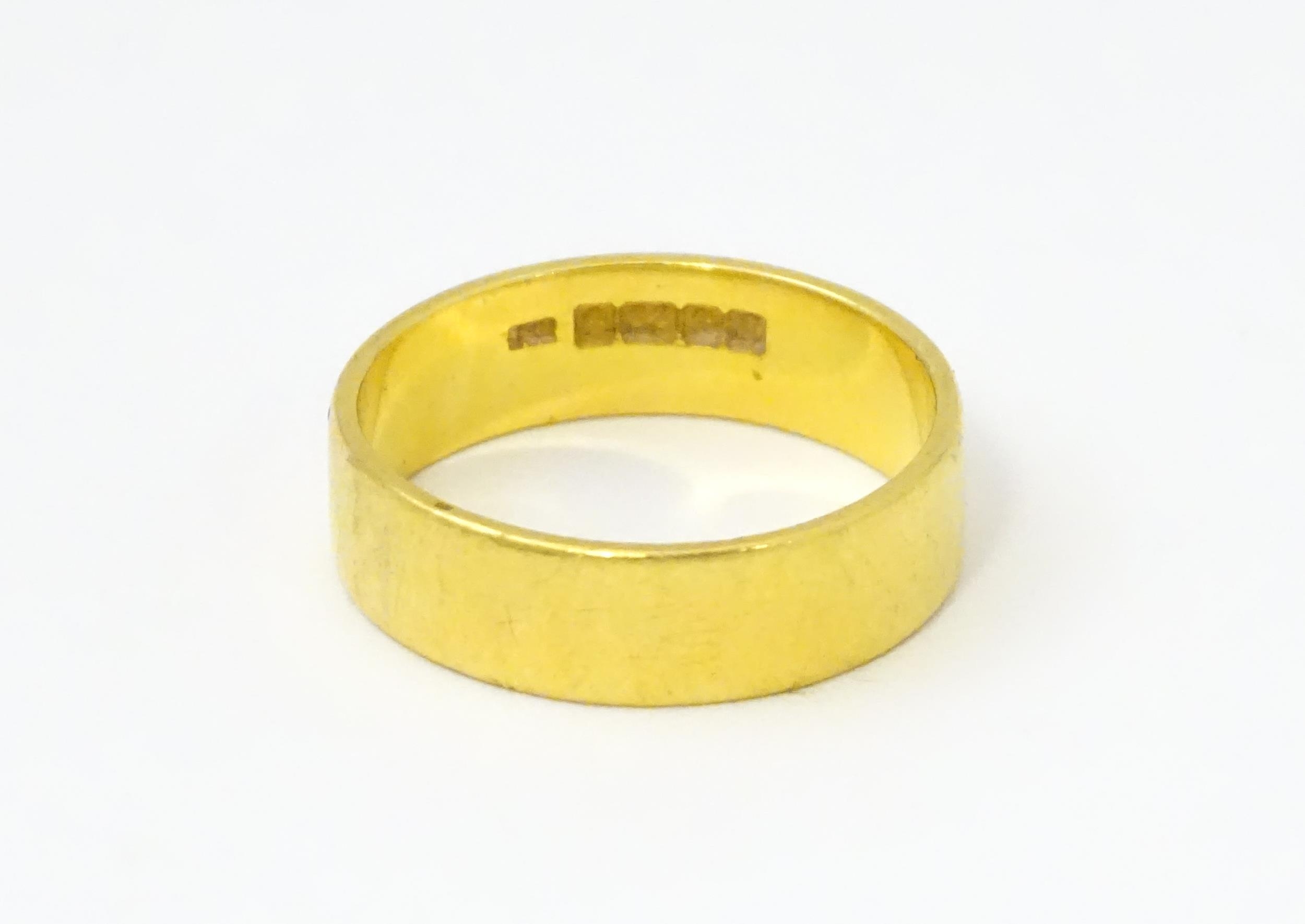 A 22ct gold ring / wedding band. Ring size approx. M 1/2 Please Note - we do not make reference to