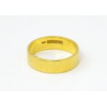 A 22ct gold ring / wedding band. Ring size approx. M 1/2 Please Note - we do not make reference to