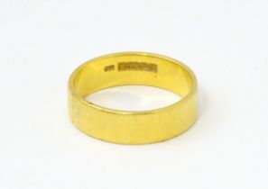 A 22ct gold ring / wedding band. Ring size approx. M 1/2 Please Note - we do not make reference to