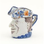 A French faience character / Toby jug, possibly modelled as Mr Punch. Approx. 3 1/4" high Please