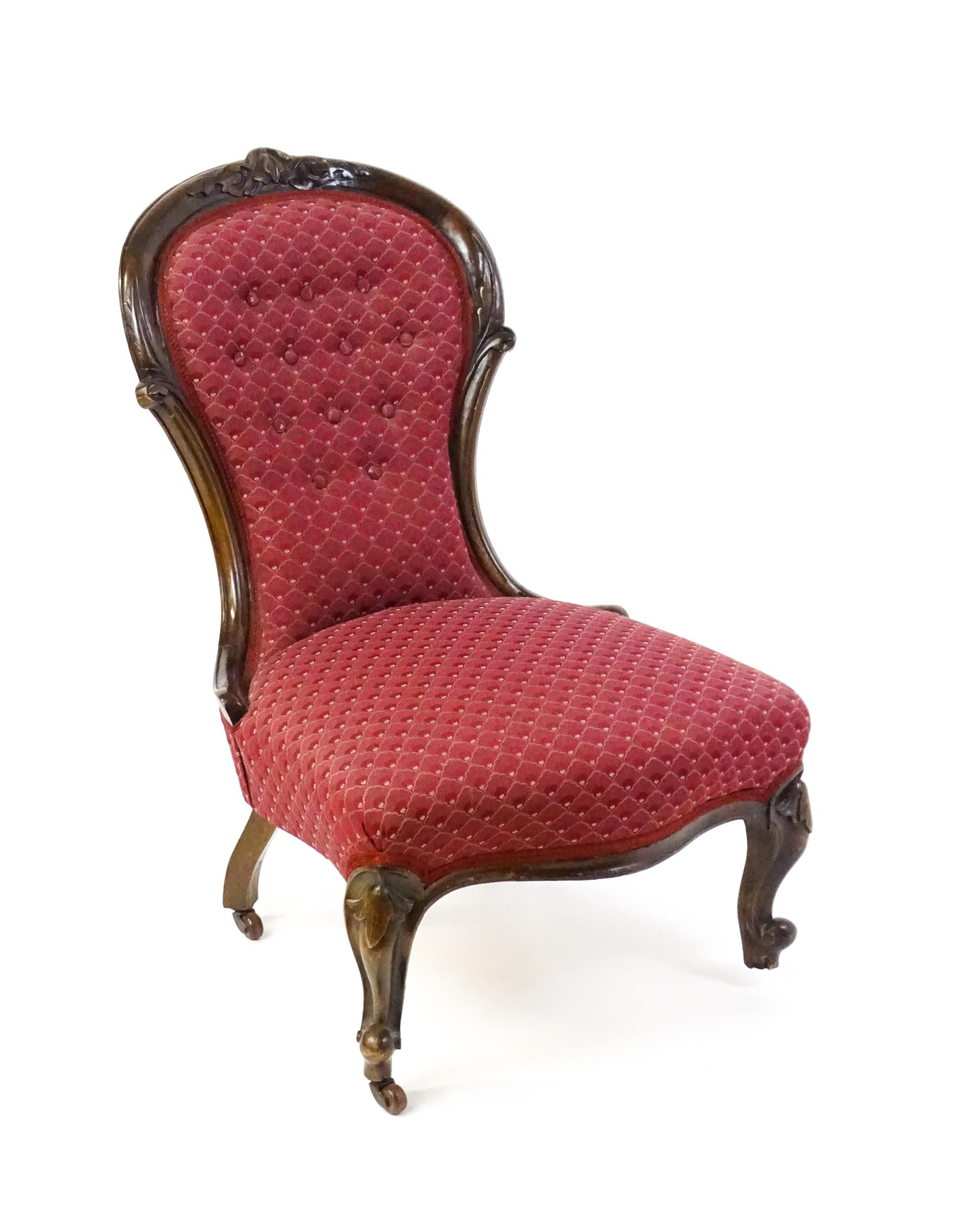 A late 19thC / early 20thC nursing chair with a deep buttoned spoon back adorned with a carved - Image 7 of 7
