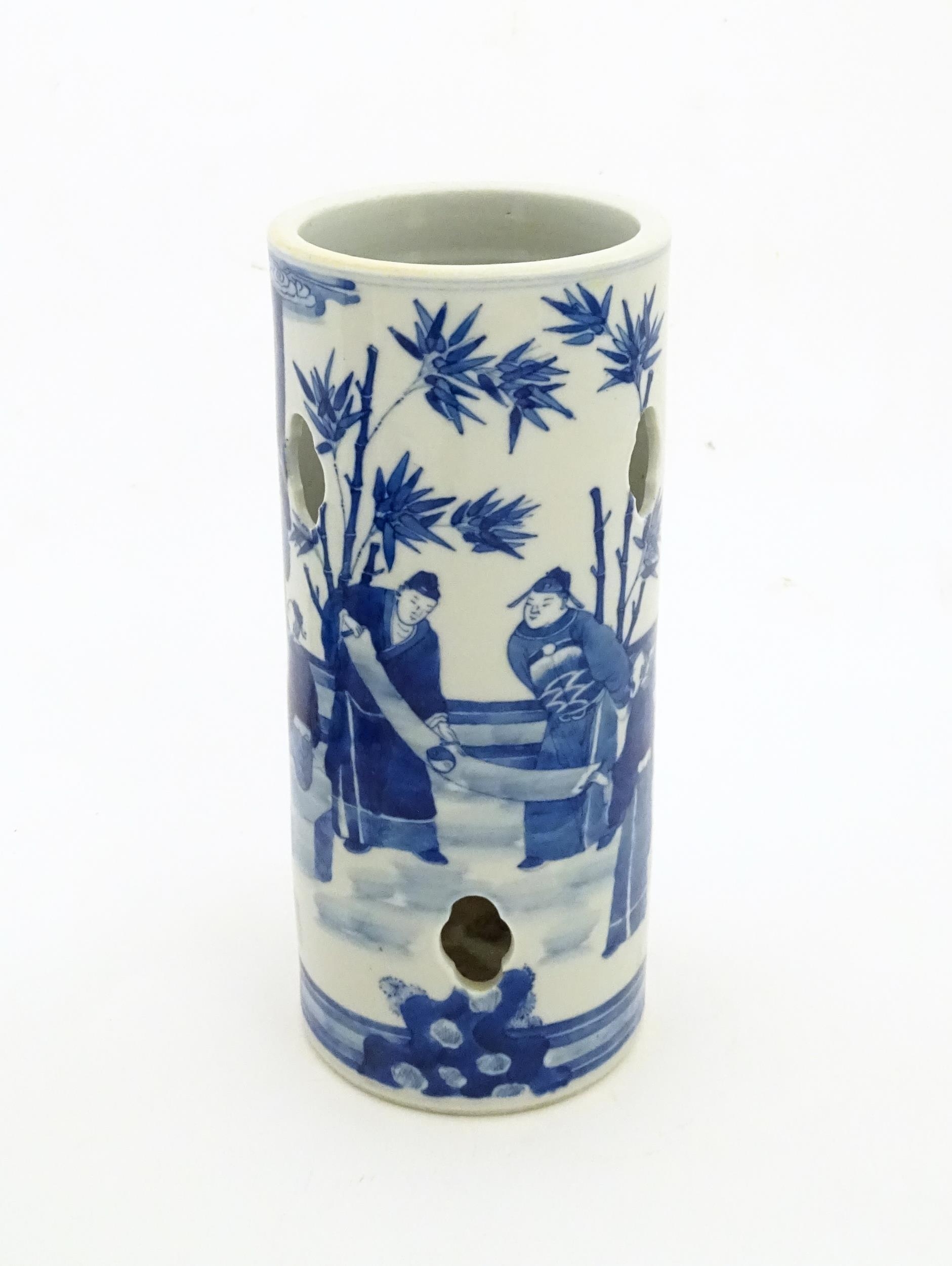 A Chinese blue and white hat stand decorated with scholars in a garden landscape. Approx. 11 1/2"