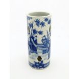 A Chinese blue and white hat stand decorated with scholars in a garden landscape. Approx. 11 1/2"