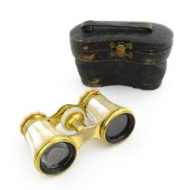 An early 20thC cased pair of binoculars by F. Niemeyer Braunschweig, the body with mother of pearl