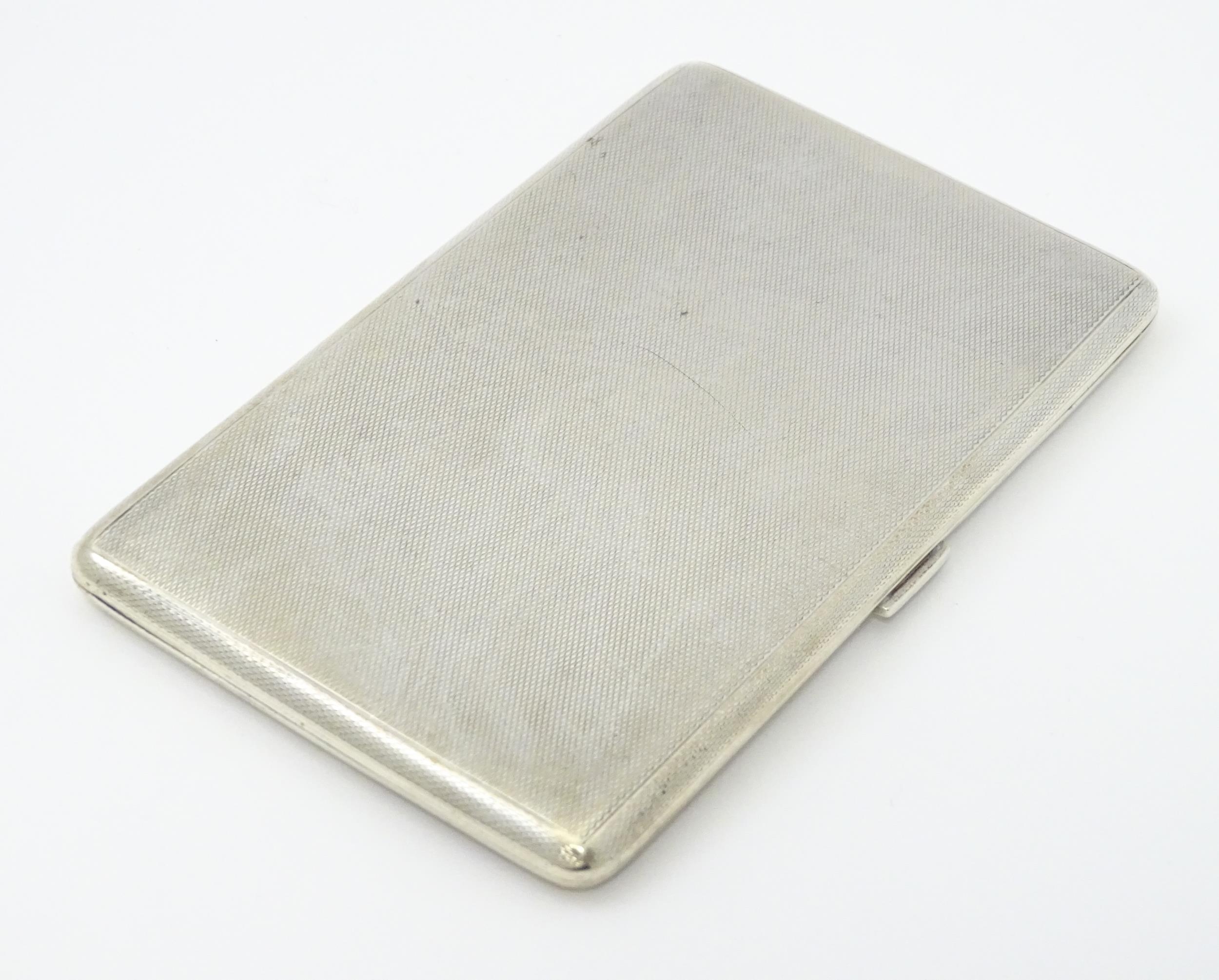 An Art Deco silver cigarette case with three sectional interior hallmarked Birmingham 1933, maker