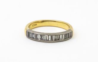 An 18ct gold half eternity ring set with 15 baguette cut diamonds. Ring size approx. M 1/2 Please