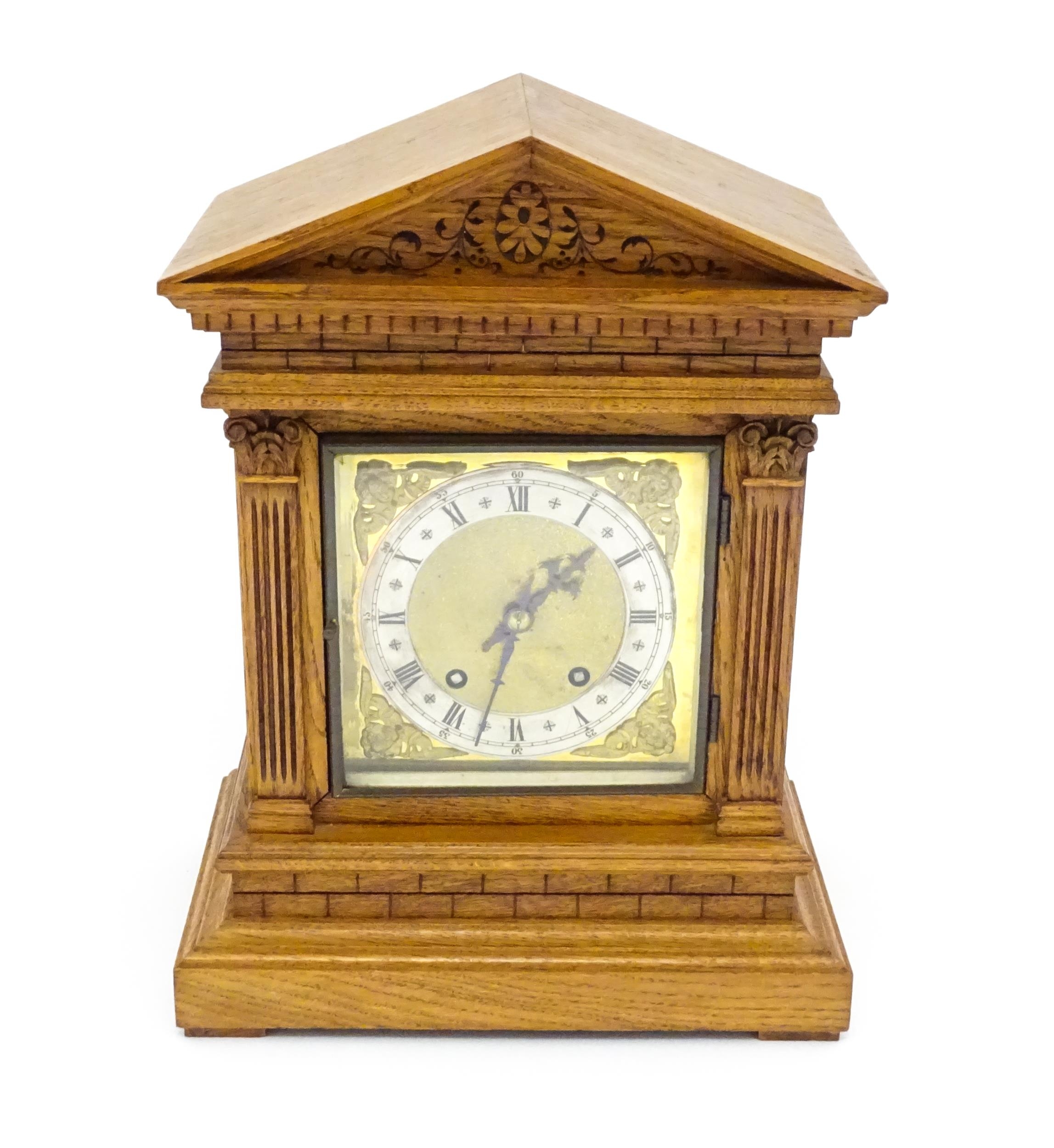 A 19thC German oak cased mantle clock by Winterhalder & Hofmeier, having a silvered chapter ring,