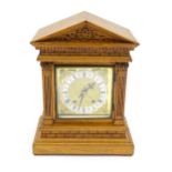 A 19thC German oak cased mantle clock by Winterhalder & Hofmeier, having a silvered chapter ring,