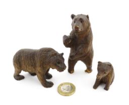 Three 20thC Black Forest style carved wooden models of bears to include a standing bear and a cub.