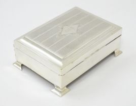 An early - mid 20thC silver table top cigarette box with engine turned decoration. Approx. 5 1/4"