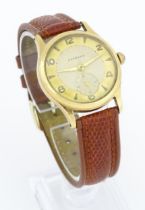 A gentlemans 9ct gold cased wristwatch the dial signed Garrard with Arabic numerals and subsidiary