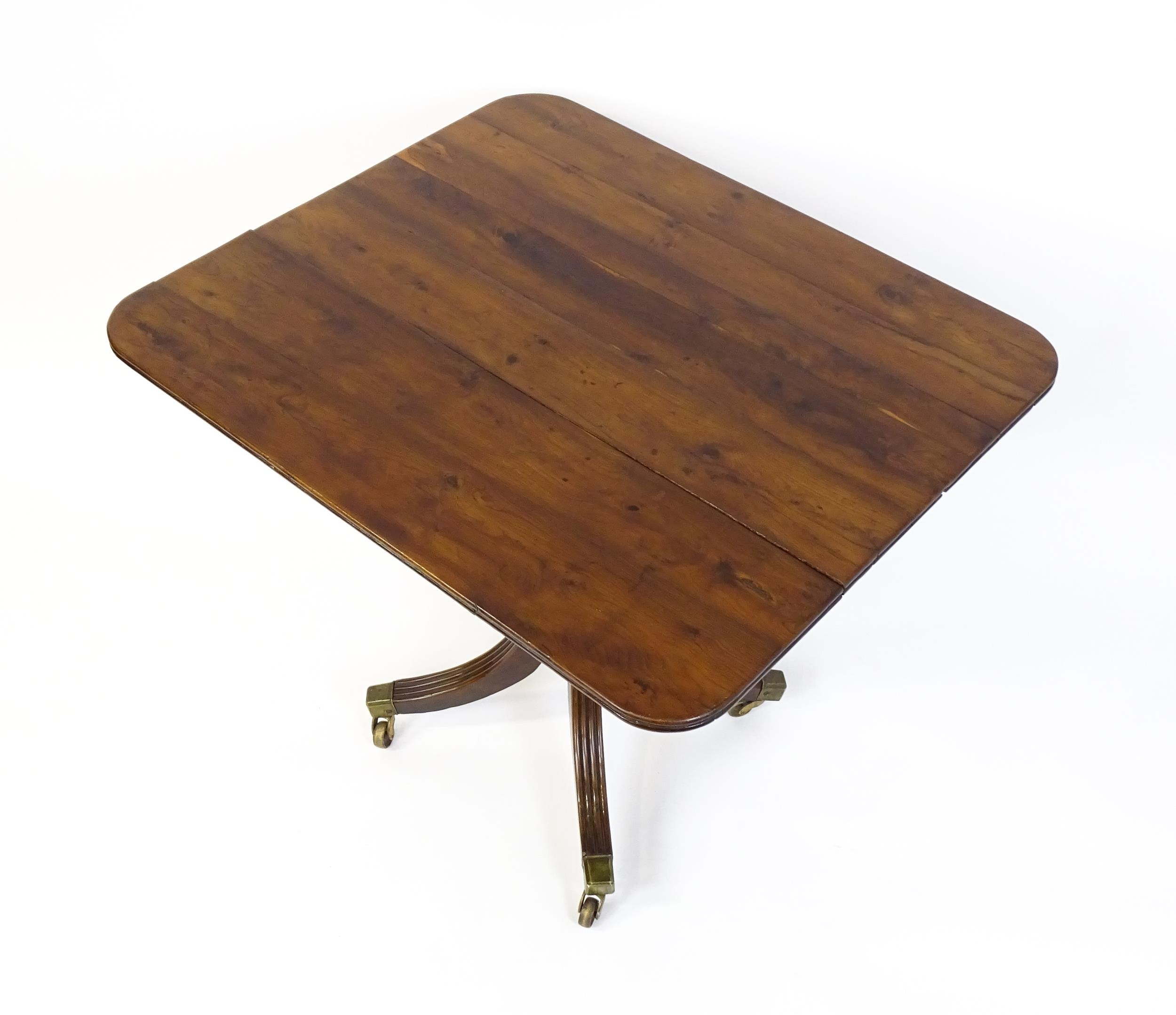 A 19thC tilt top occasional table with yew wood planked top above a reeded mahogany pedestal and - Image 11 of 13