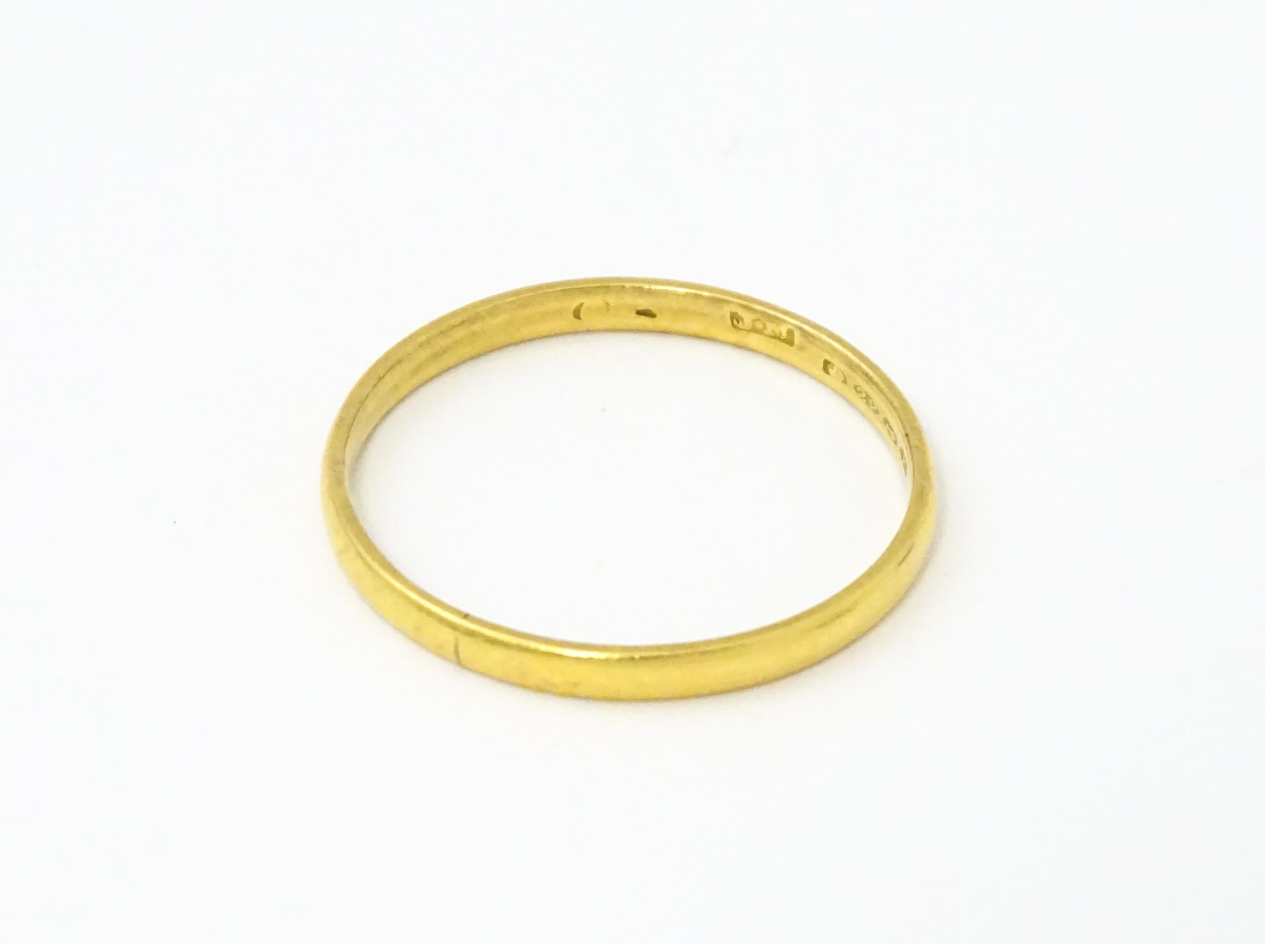 A 22ct gold ring. Ring size approx. Y. (2.9g approx) Please Note - we do not make reference to the