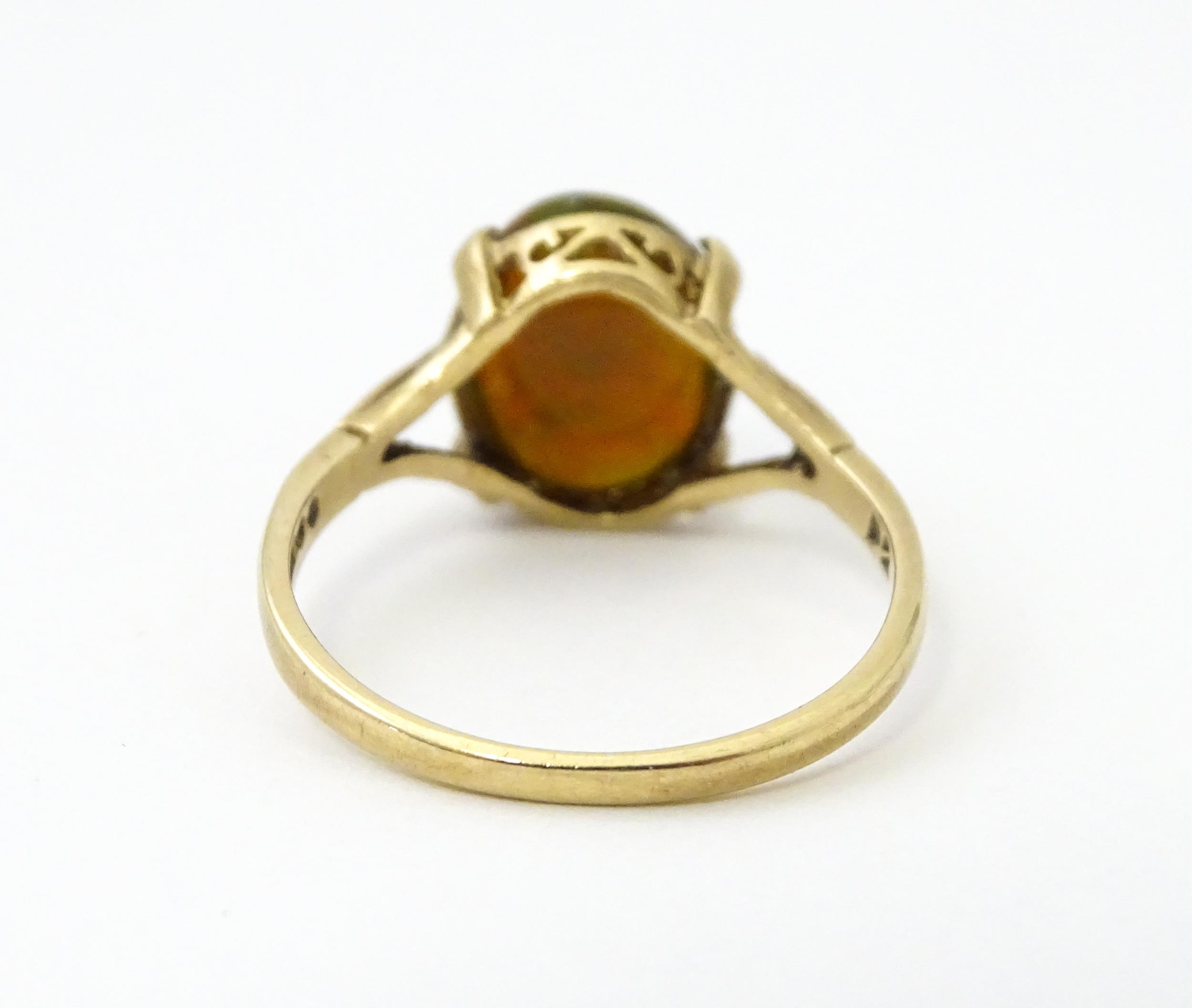 A 9ct gold ring set with fire opal cabochon. Ring size approx. R. Please Note - we do not make - Image 6 of 7