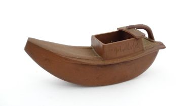 A Chinese Yixing teapot modelled as a boat with incised Character marks and Character seal under.