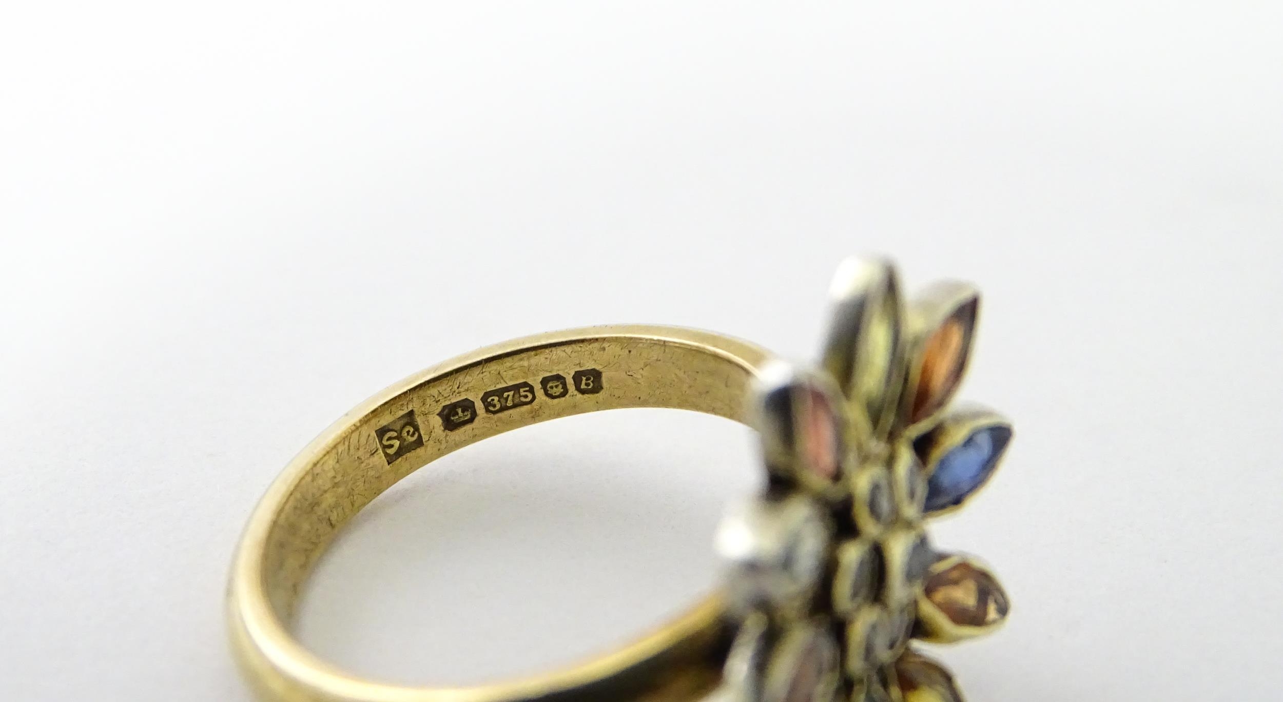 A 9ct gold ring set with central diamonds bordered by various coloured stones in a flower setting. - Image 4 of 6