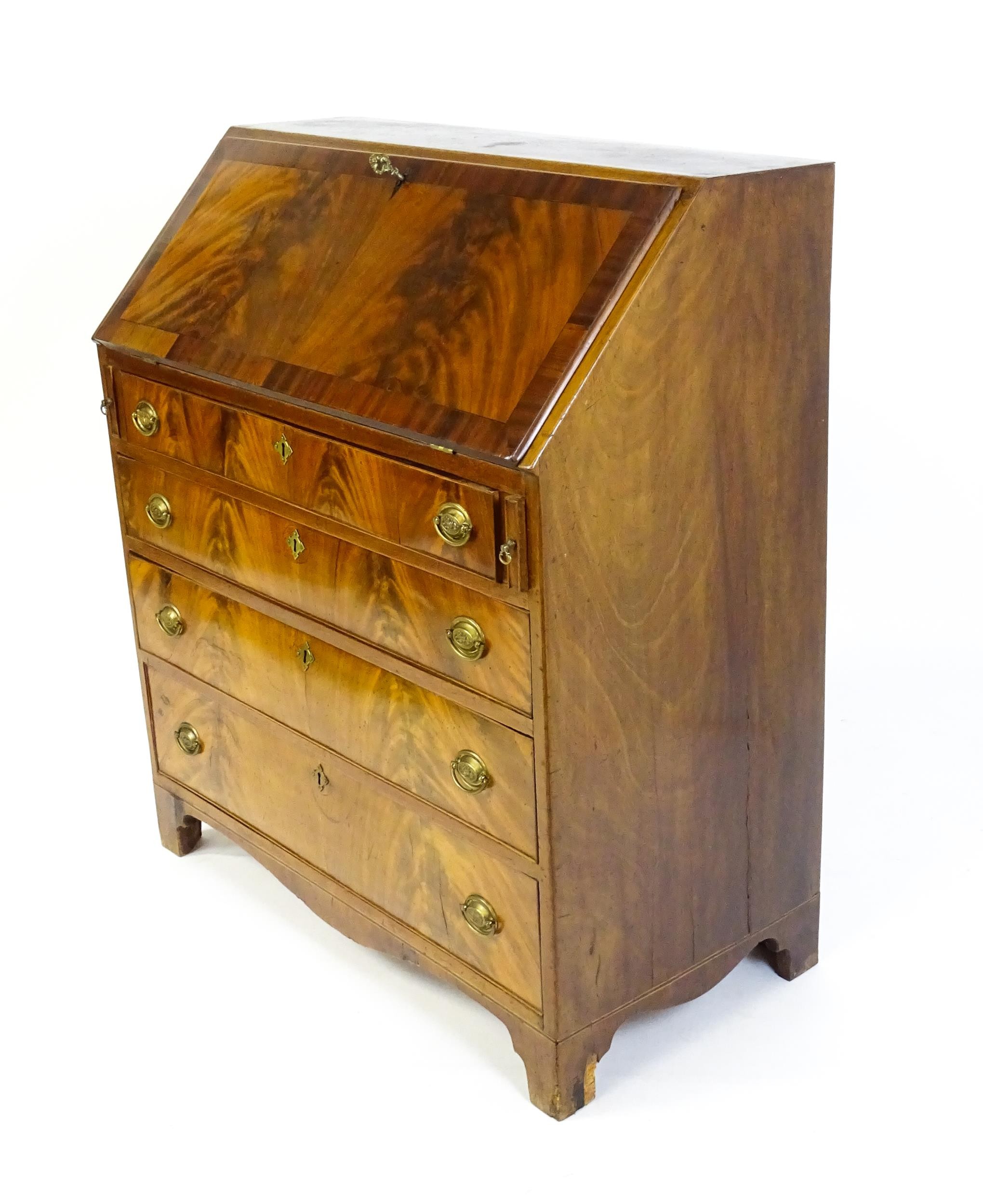 An early 19thC mahogany bureau with a fall front above four long graduated drawers with brass back - Image 6 of 6