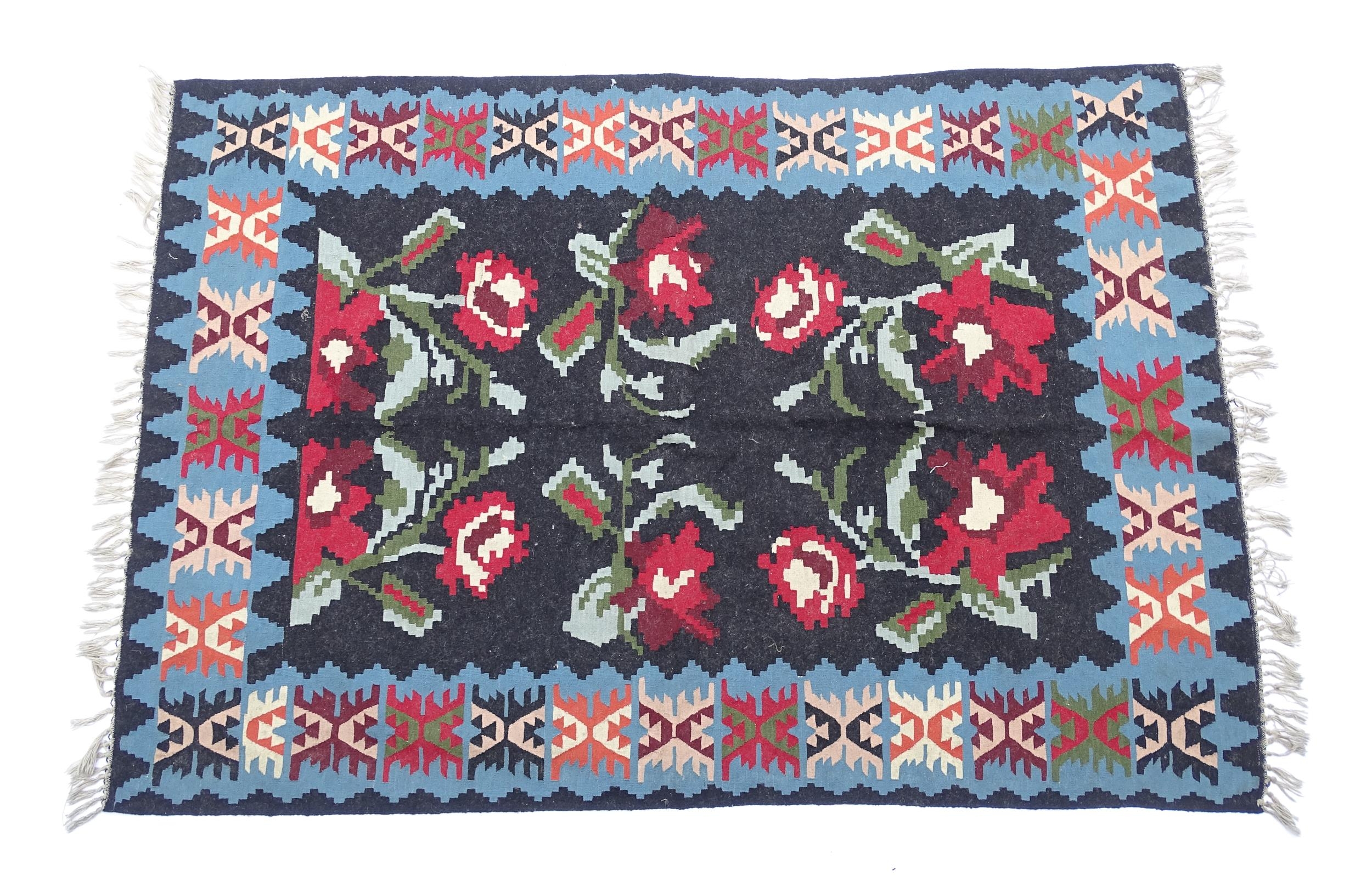 Carpet / Rug : A black ground rug with red floral decoration, with geometric motifs to borders. - Image 3 of 9