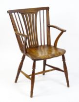 A late Georgian Windsor chair with a fanned back splat, a shaped seat and raised on turned